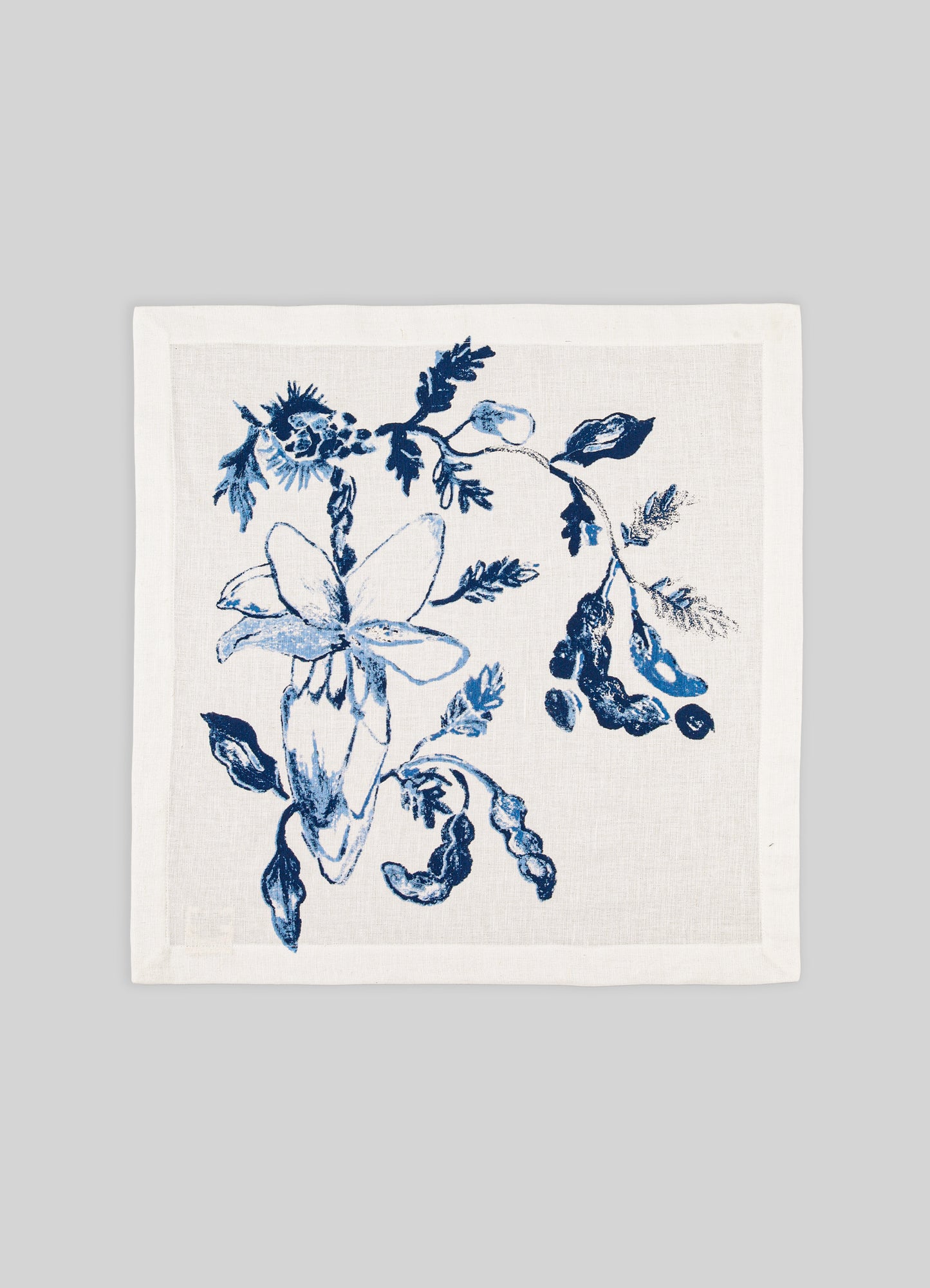 White towel with blue floral design on a gray background