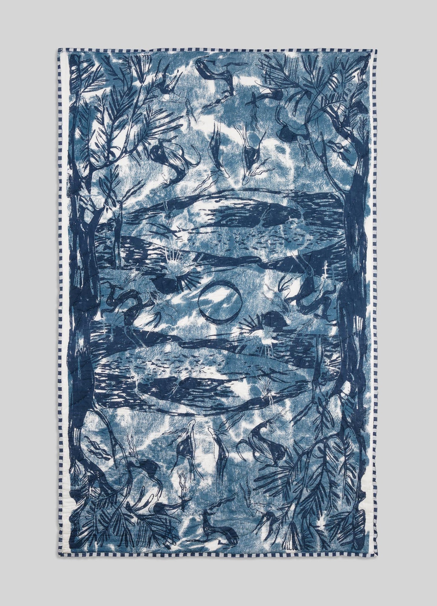 Blue and white patterned towel on a light gray background viya