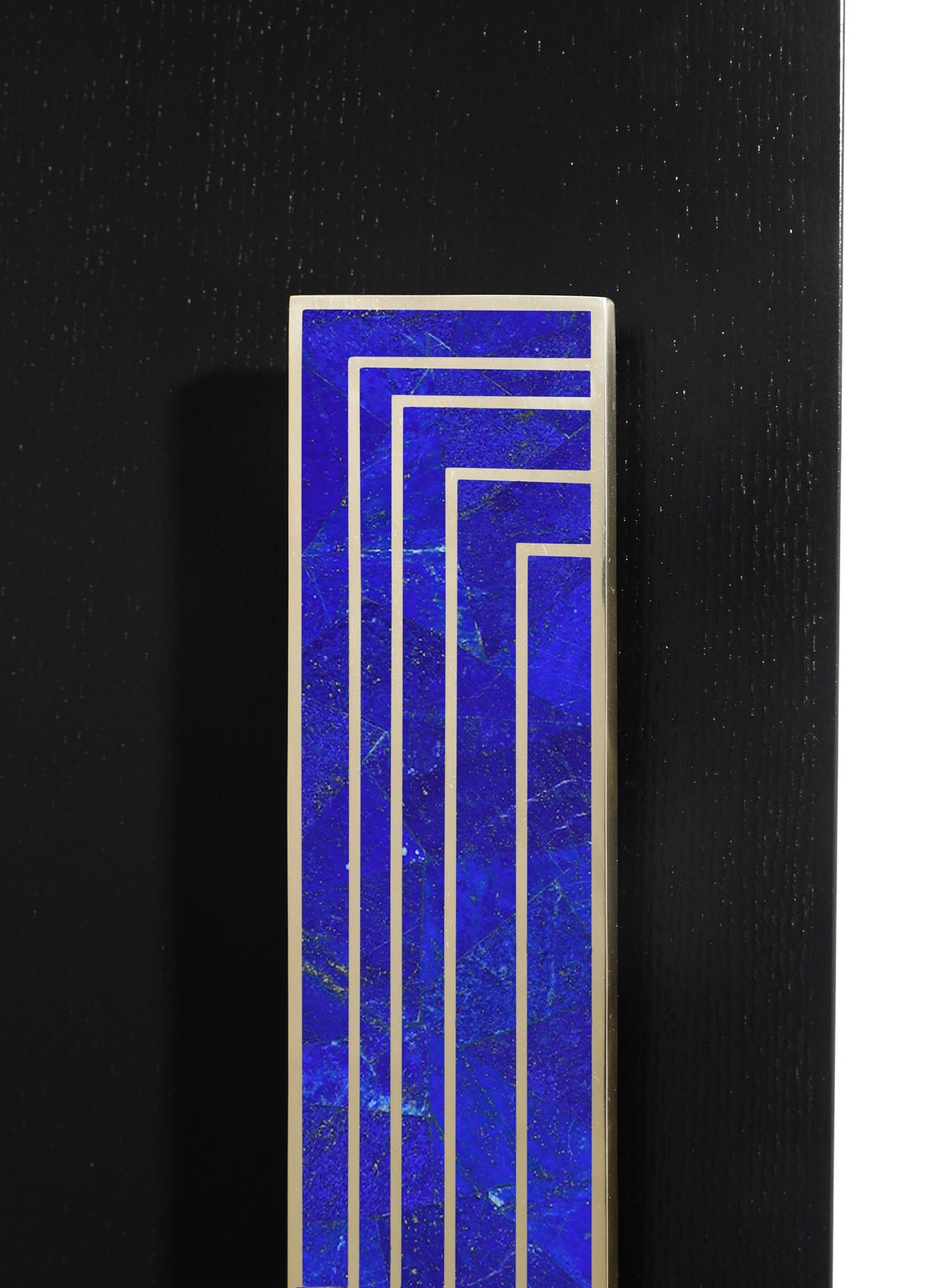 A tall rectangular decorative object featuring a deep blue stone with veining, framed by metallic silver borders, set against a dark textured background.