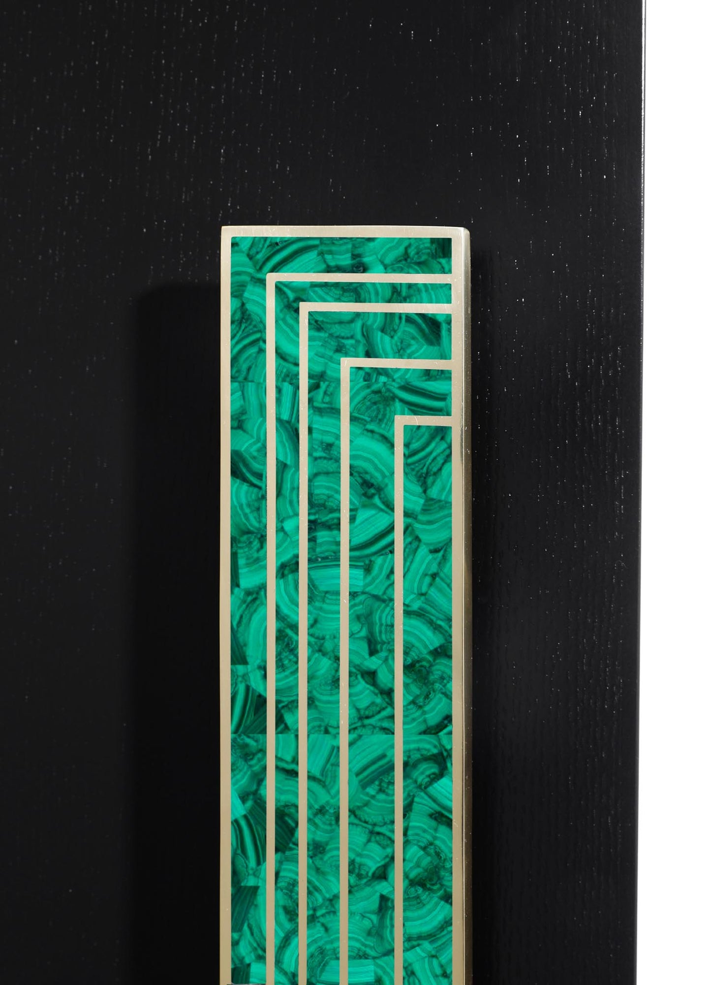 A decorative panel with geometric metal framing and a green malachite-like inlay, featuring swirling natural patterns, mounted on a black textured background.