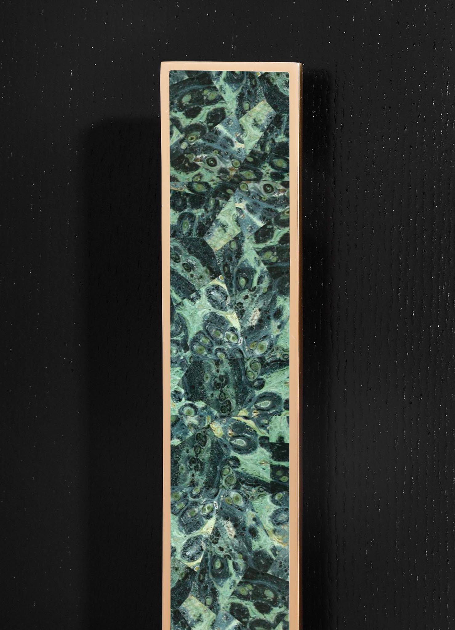 A tall, rectangular decorative panel featuring a green and black marbled pattern with swirling, abstract motifs, enclosed in a light-colored frame.