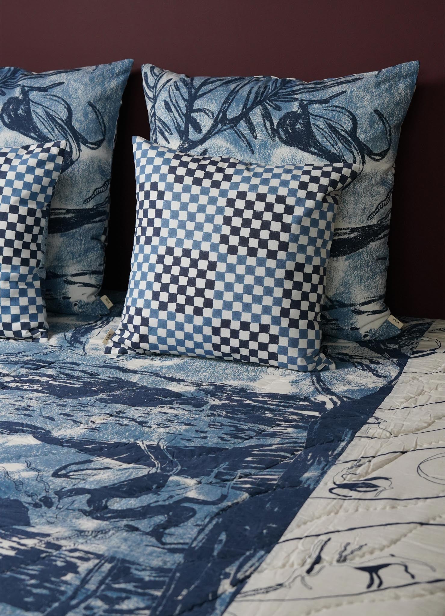Blue and white checkered pillow cover on a bed with matching bedding luxury cushion cushions covers viya