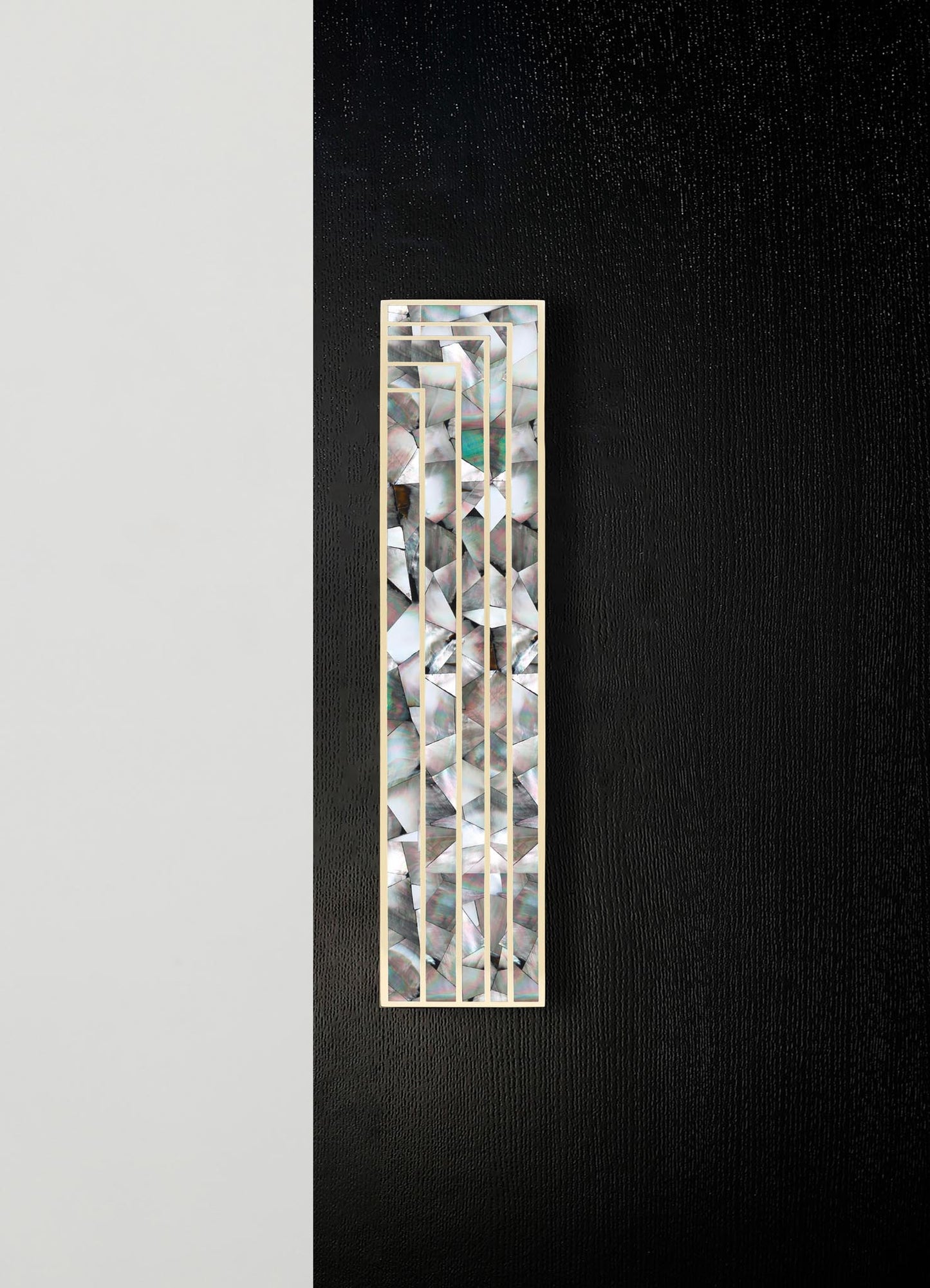 Decorative wall panel with mosaic shell inlay and a geometric metal frame, featuring an iridescent, multicolored pattern on a black and white background.