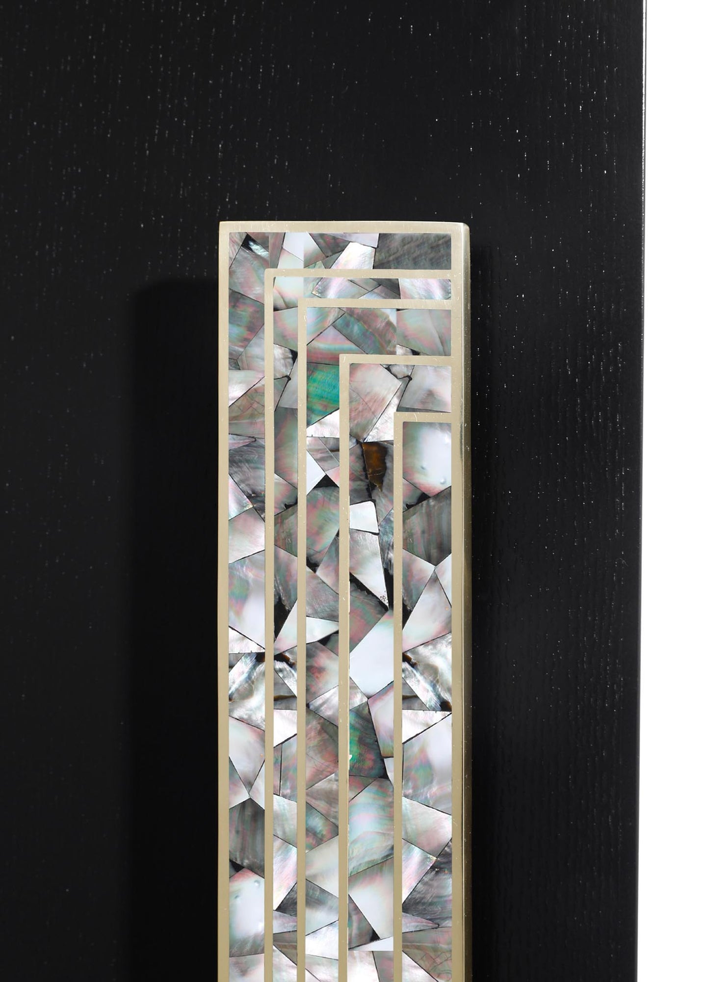A decorative panel featuring an inlaid abalone shell with iridescent, geometric patterns framed by a brass border, set against a dark background. The design incorporates natural shell motifs with a contemporary, minimalist style.