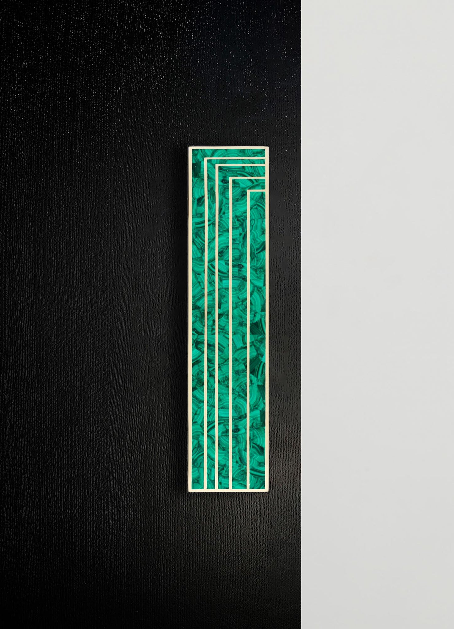 A tall, rectangular wall art piece featuring a marbled green and black pattern with white linear accents, mounted on a textured black wall. The artwork has a contemporary style with geometric and abstract motifs.