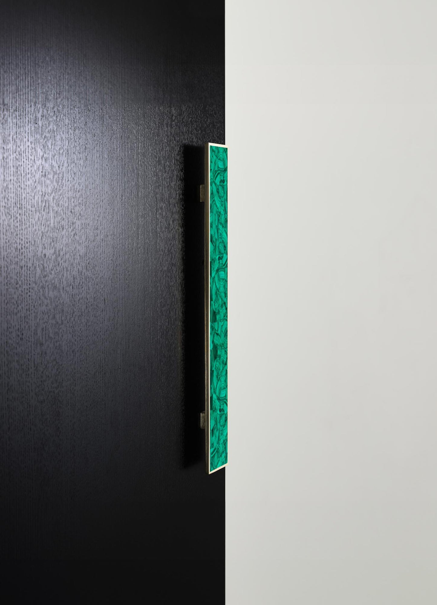 A modern wall-mounted art piece with a rectangular shape featuring a green marbled pattern and a gold frame, displayed against a black and white split background.