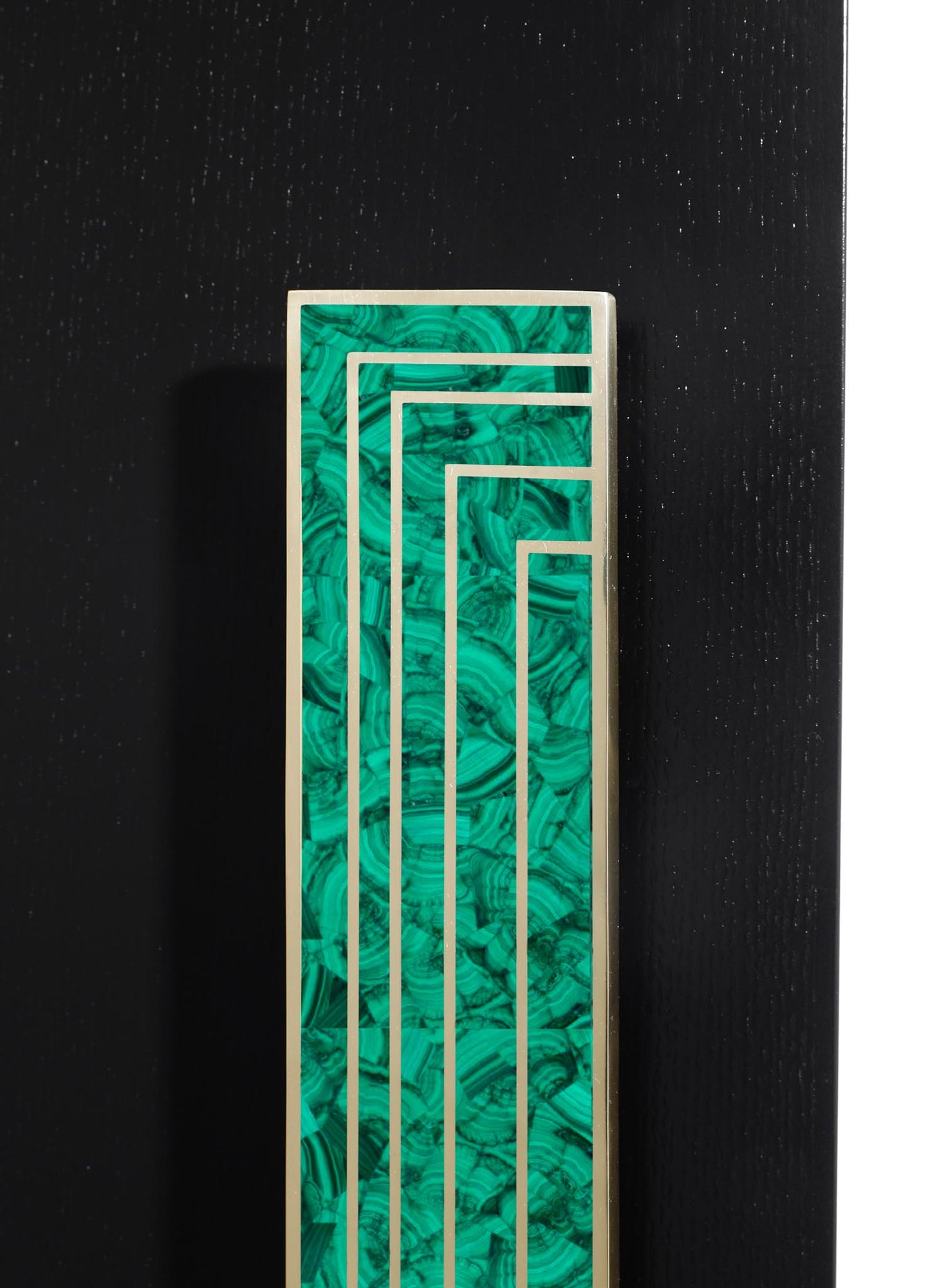 A rectangular decorative panel featuring a green malachite pattern with swirling, layered motifs, framed by a metallic border, set against a black background.