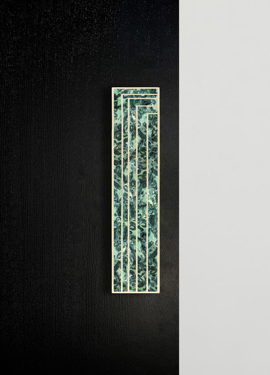 A decorative wall panel featuring a geometric design with multiple rectangular frames and a marbled pattern in shades of green and blue, bordered by light-colored wood.