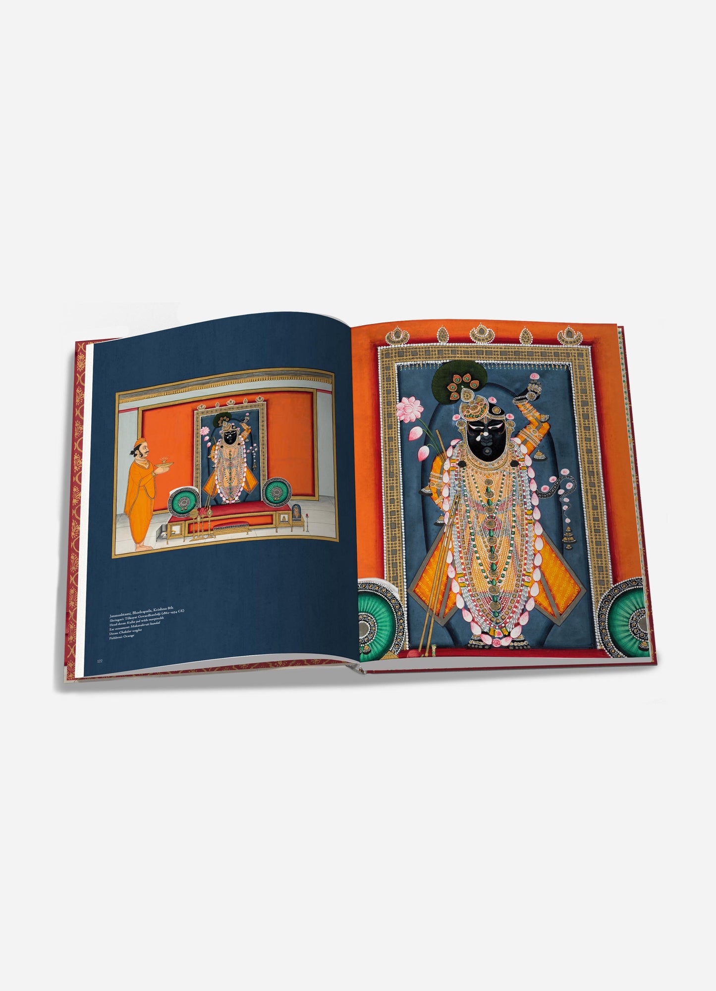 This image features an open book displaying colorful illustrations of traditional Indian deity portraits with ornate jewelry, vibrant clothing, and decorative backgrounds. The artwork includes detailed motifs, rich colors like blue, orange, and gold, and intricate patterns.
