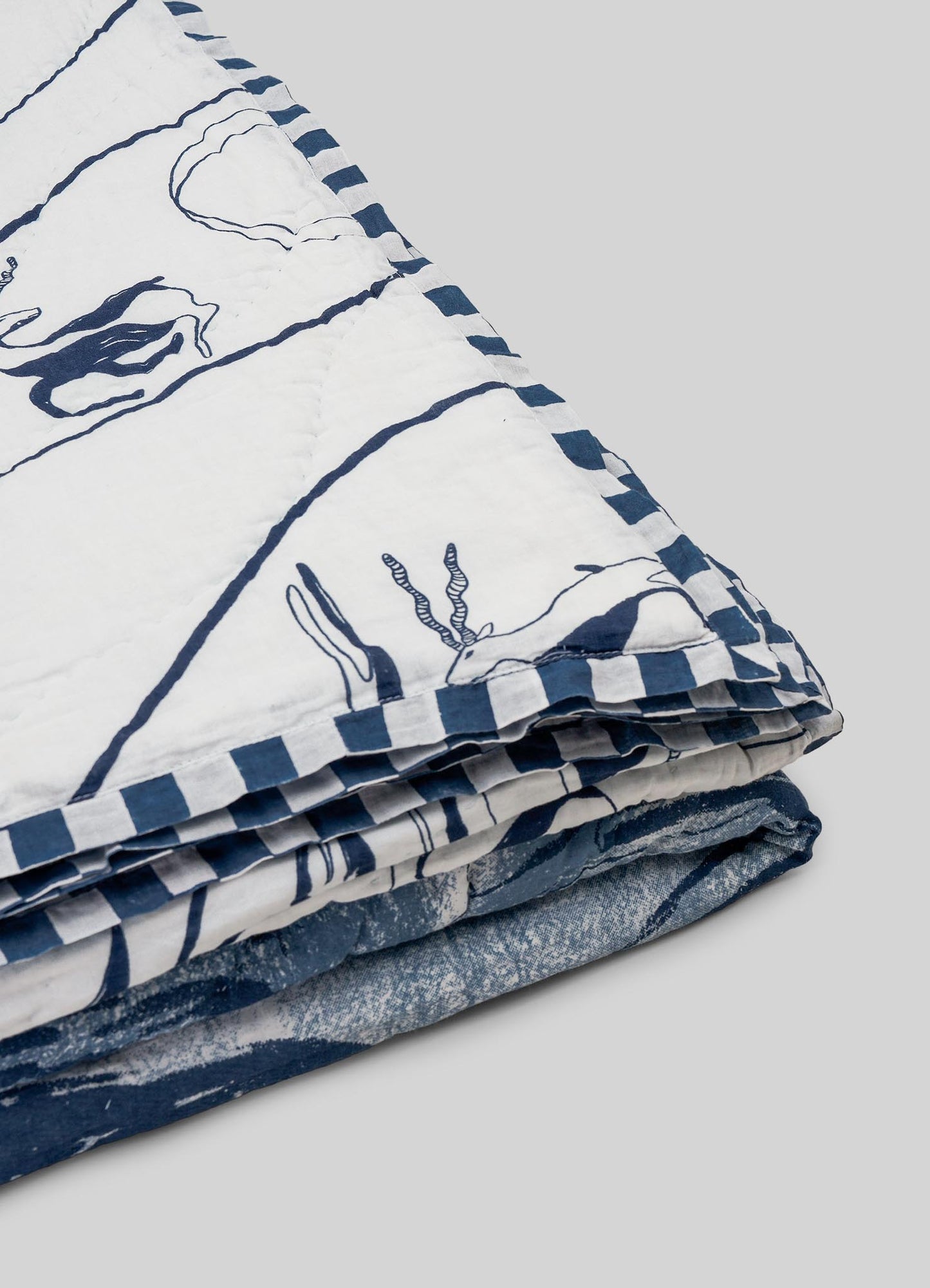Folded fabric with blue and white pattern luxury king size quilts viya