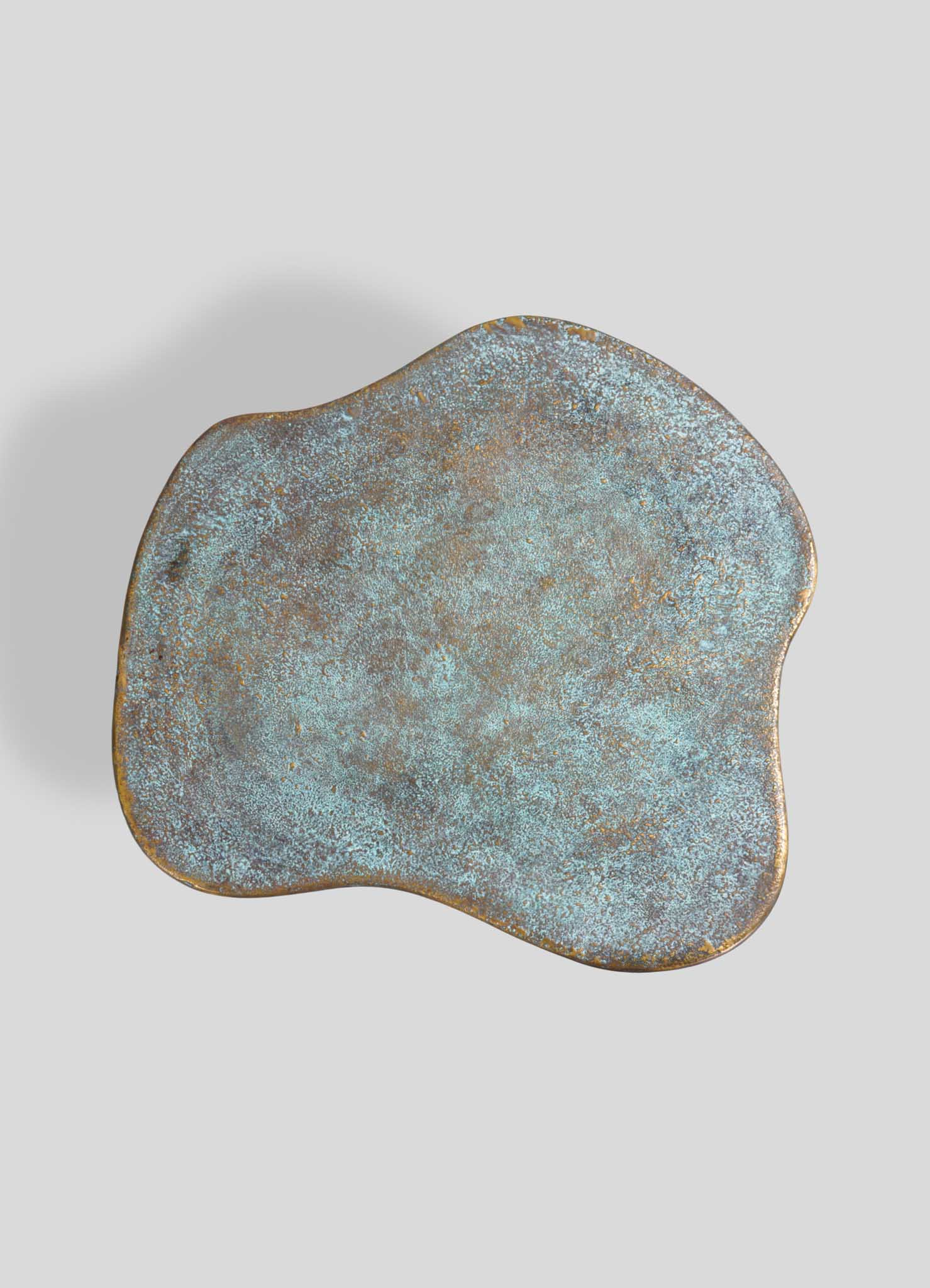 Artistic bronze and turquoise side table with organic irregular shape, luxury accent furniture for modern living room or bedroom decor.