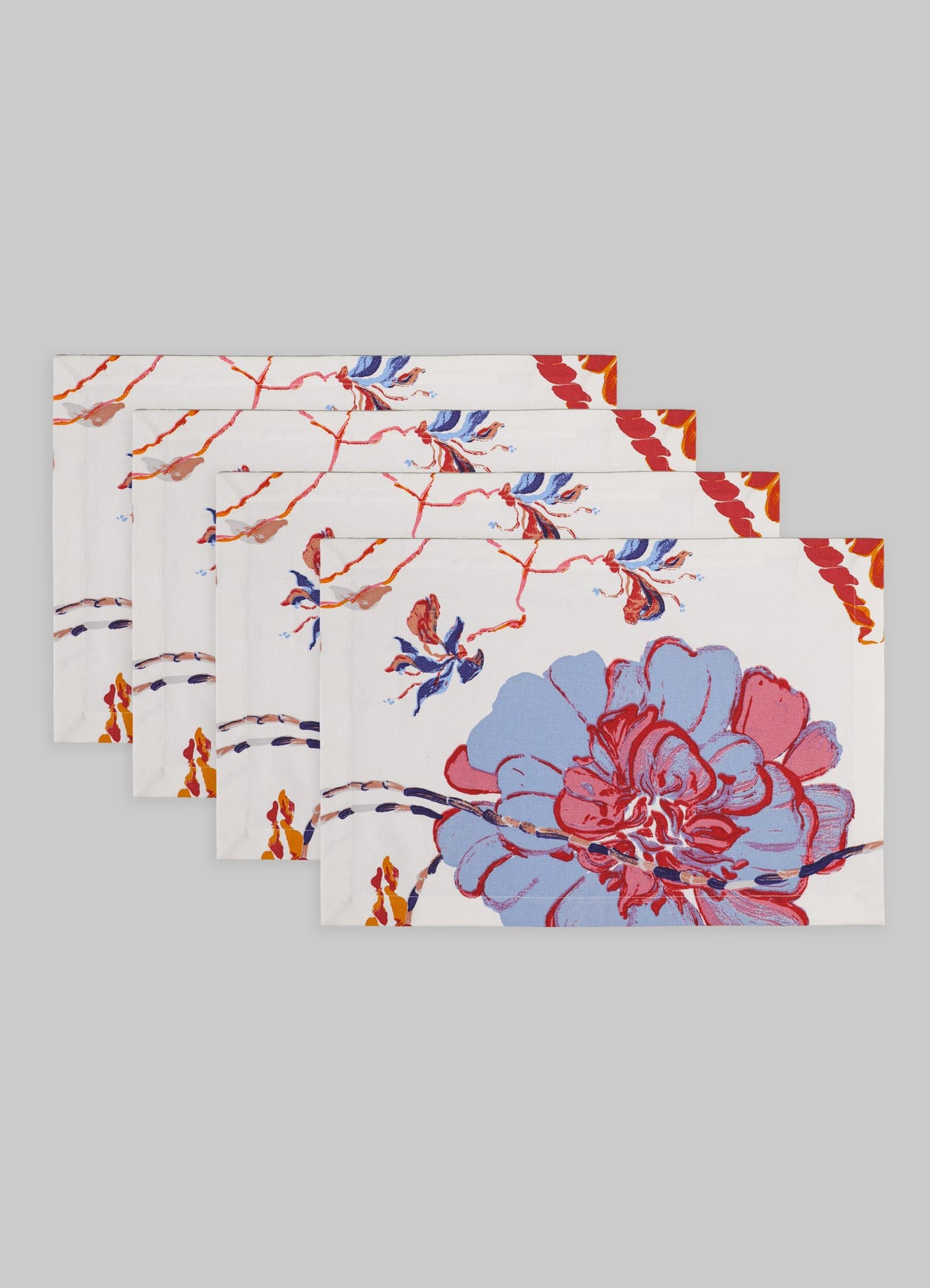 Set of six cotton napkins with a floral motif in red, blue, and orange tones on a white background, featuring a painterly design with large blossoms and delicate branches.