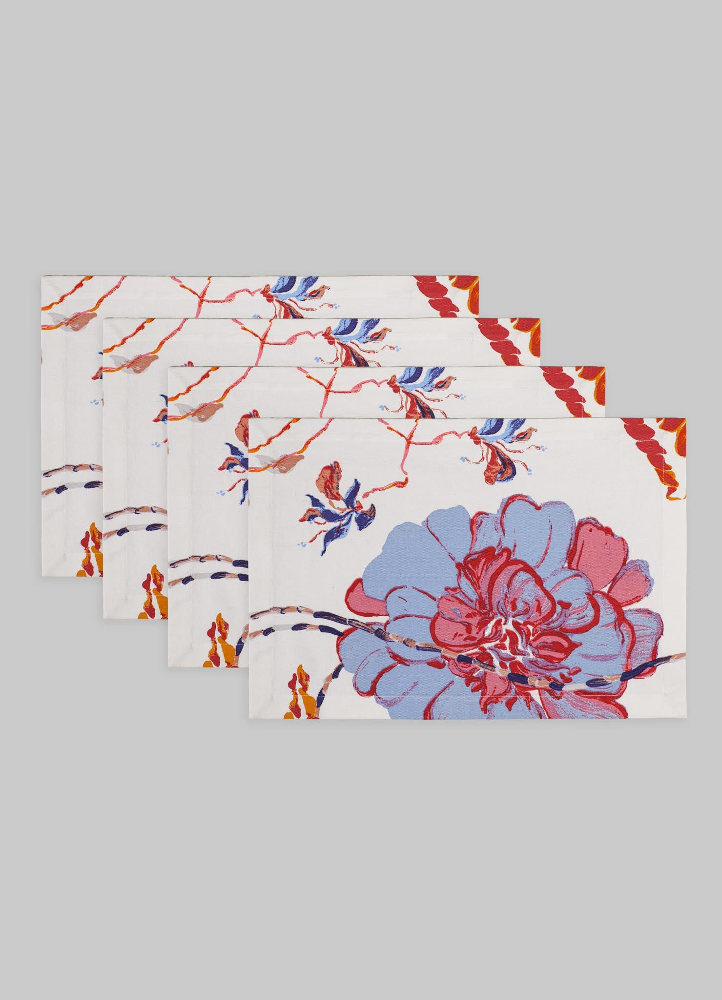 Set of six cotton napkins with a floral motif in red, blue, and orange tones on a white background, featuring a painterly design with large blossoms and delicate branches.
