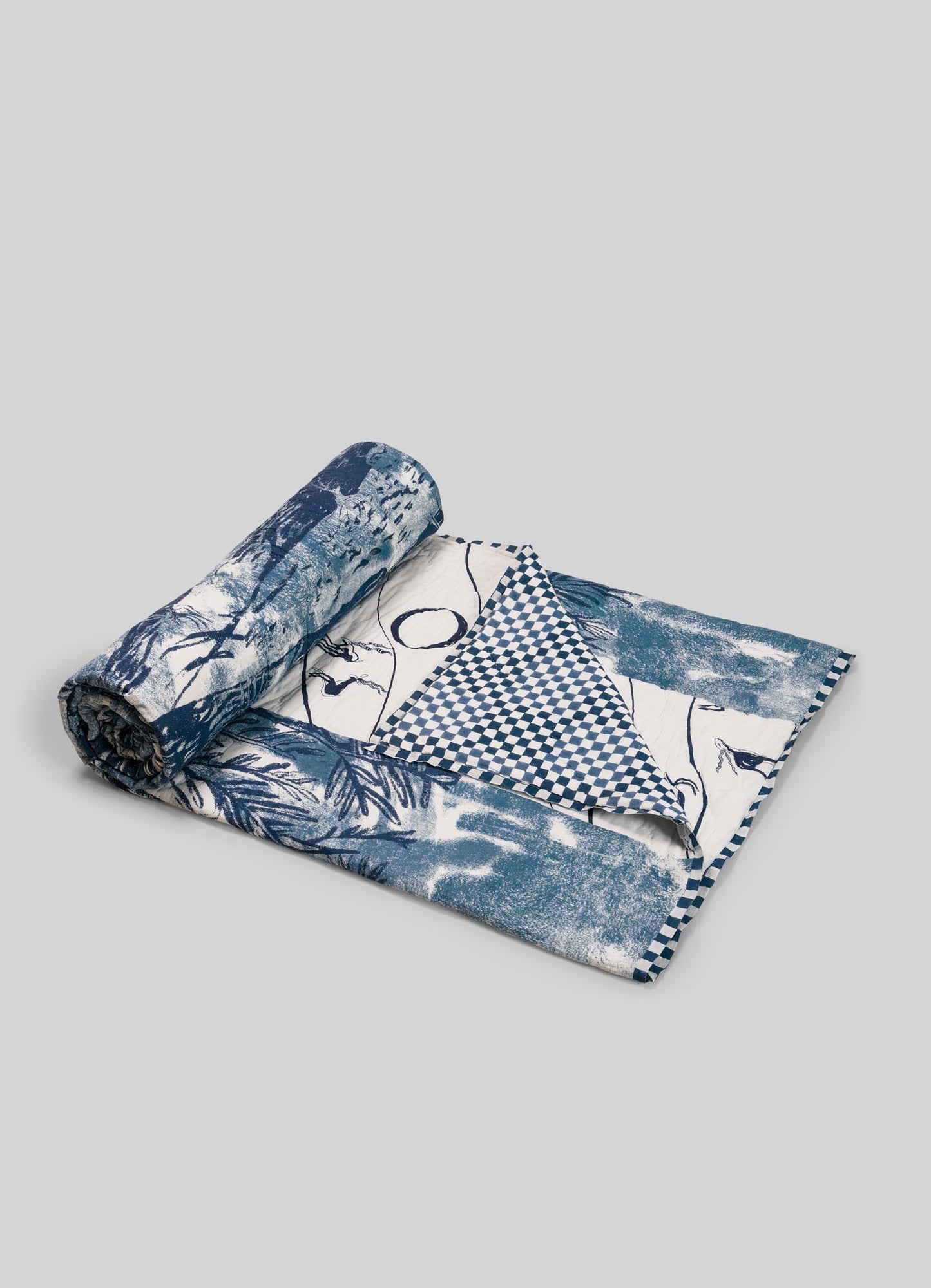 Rolled-up fabric with blue and white luxury king size quilts viya