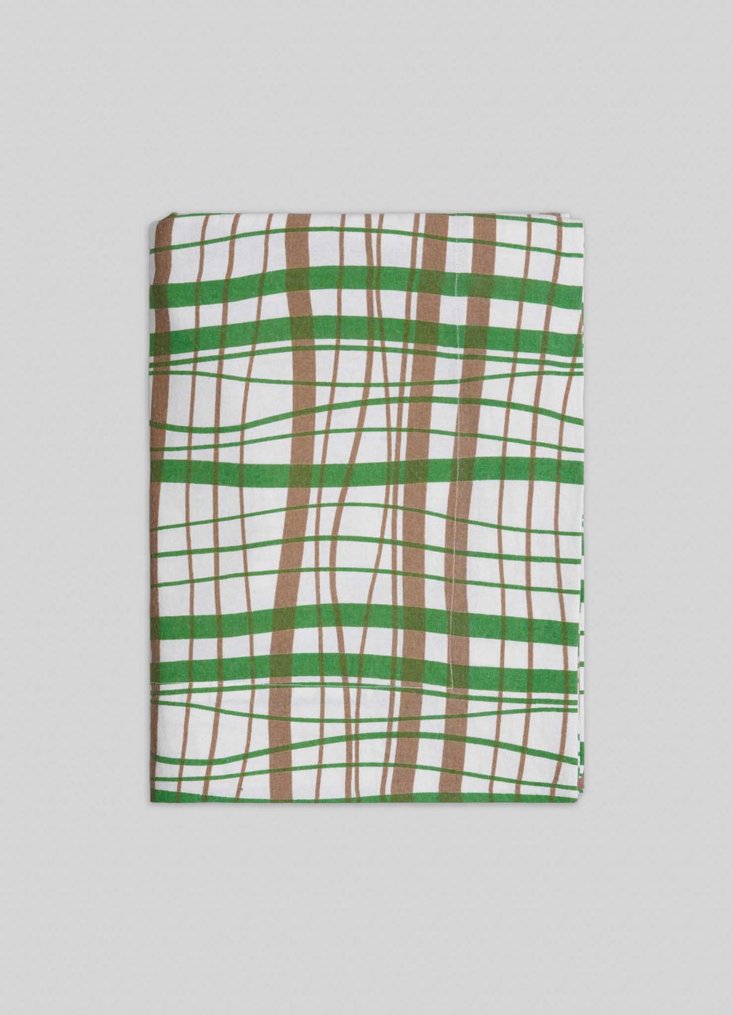 The Viya Madras Check Green & Beige Table Cloth features contemporary green, brown, and white checks, reflecting Indian textile tradition, and is shown folded on a light gray background.