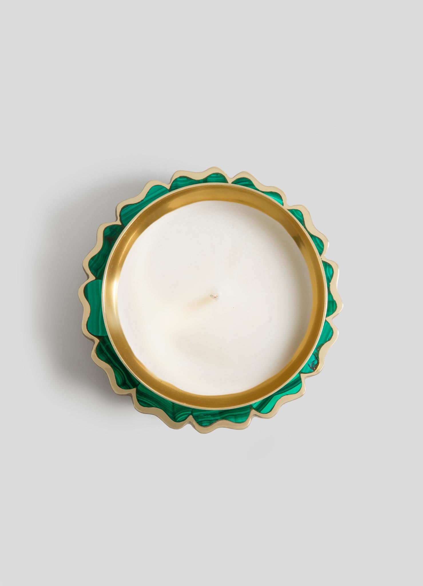 The Mystical Marigold Green Scented Candle Diya Large by Viya is a round white candle in a gold and green wavy-edged holder with semi-precious stone inlay, shown from above on a light gray background.