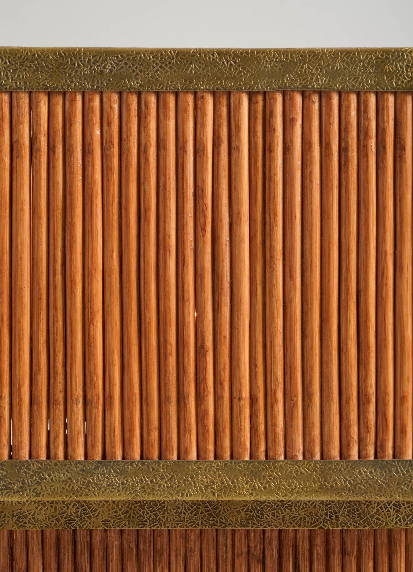 The Namsai Table Lamp Large by VIYA features vertical wooden rods with decorative brass trim at the top and bottom, forming a textured, symmetrical panel set against a neutral background.