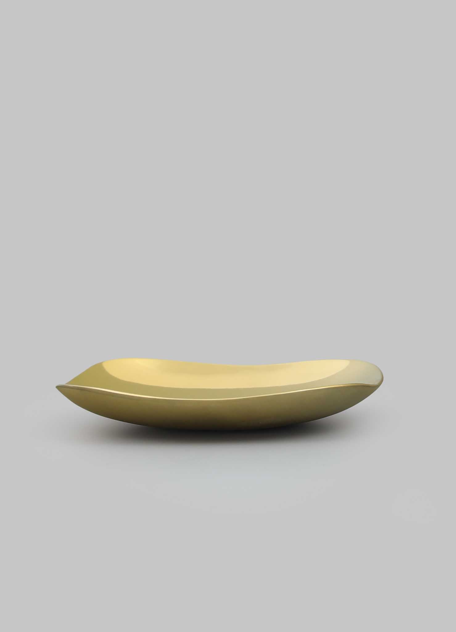 The VIYA Nazar Battu Trinket Bowl Large is a sleek, gold, oval-shaped dish with smooth, curved edges displayed on a plain light gray background, capturing the elegance of a modern Nazar amulet.