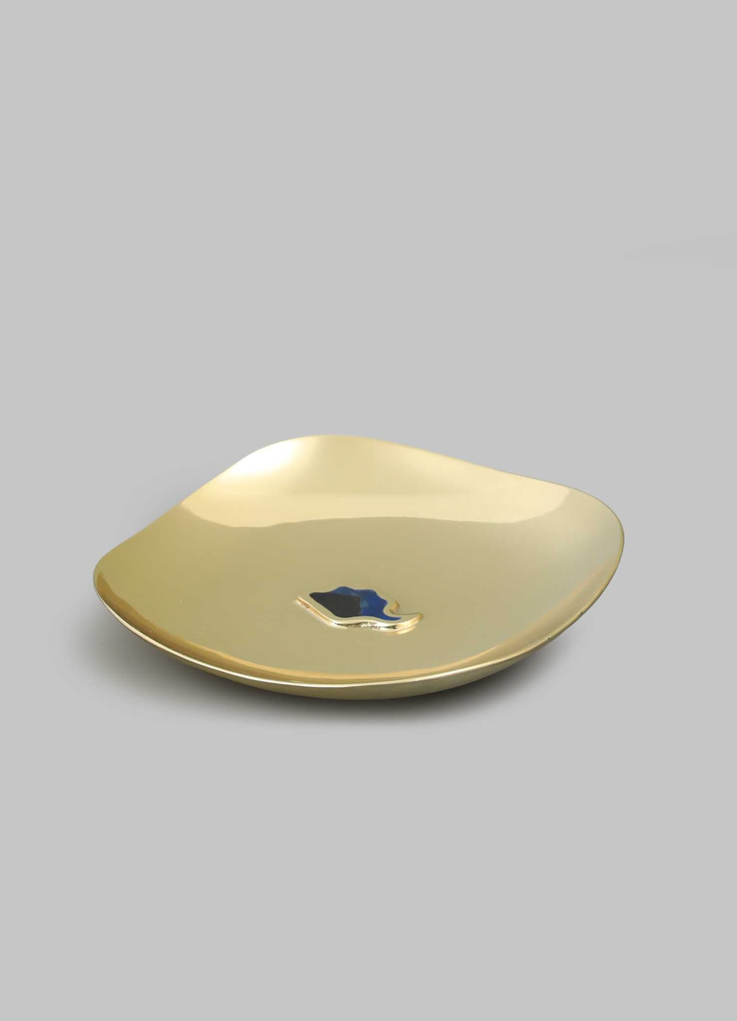 The VIYA Nazar Battu Trinket Bowl Large is a shiny gold, square-shaped bowl with curved edges and a small blue Nazar amulet in the center, displayed on a plain gray background.