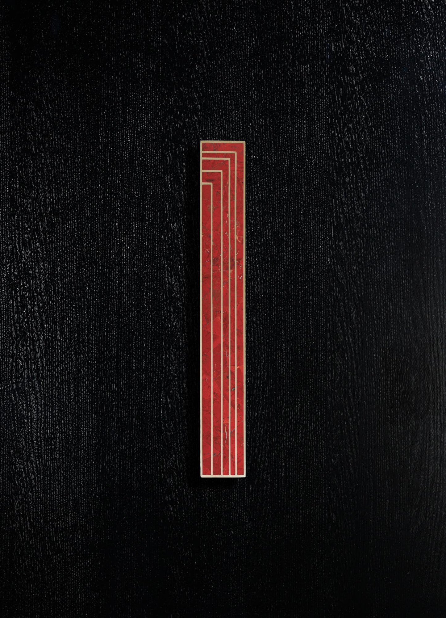 A vertical red and gold decorative panel with geometric lines and a marble-like texture, set against a black textured background.