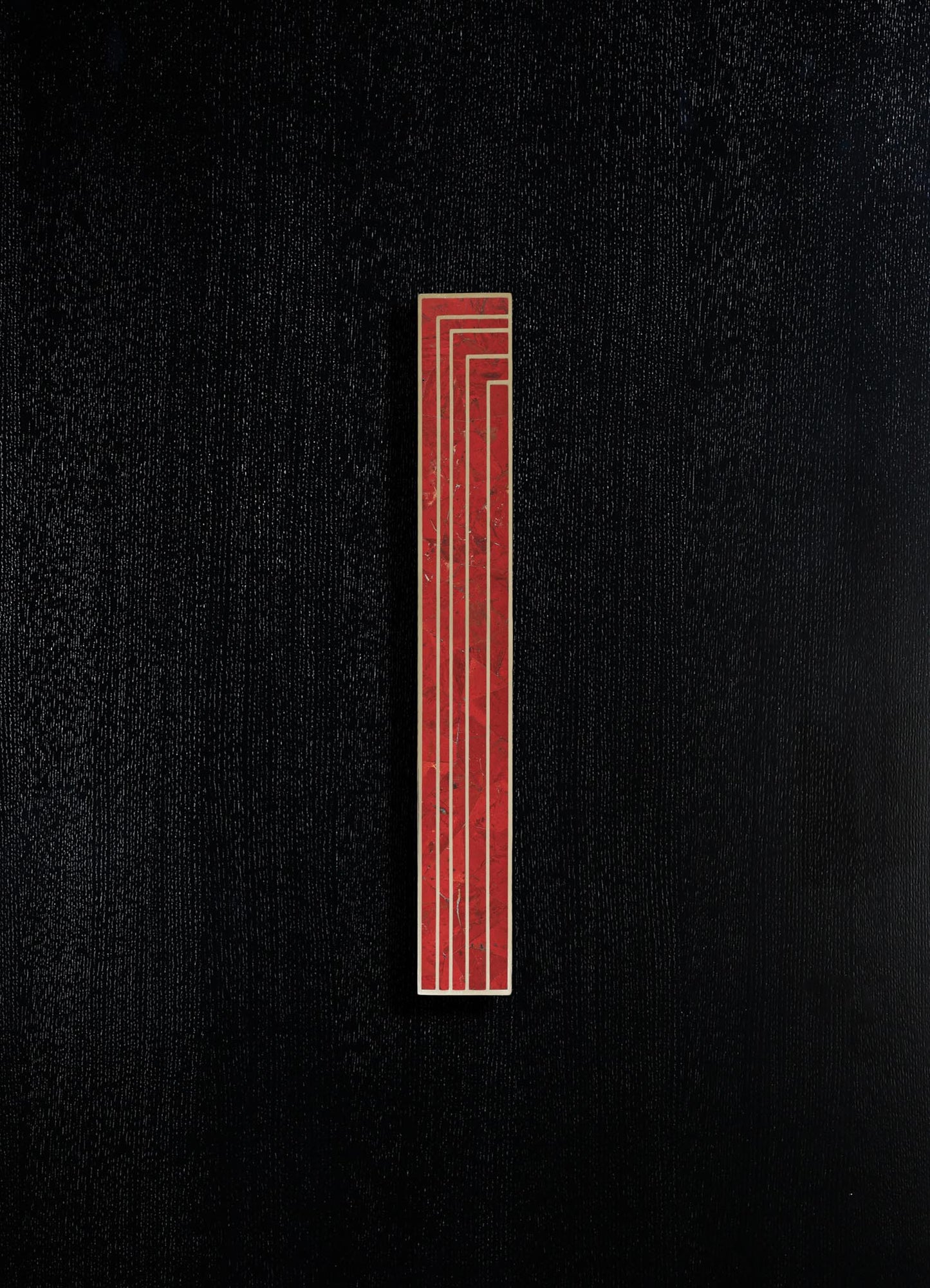 A black textured surface with a vertical red geometric motif featuring thin white lines. The design has a modern, minimalist style with an emphasis on bold color contrast.