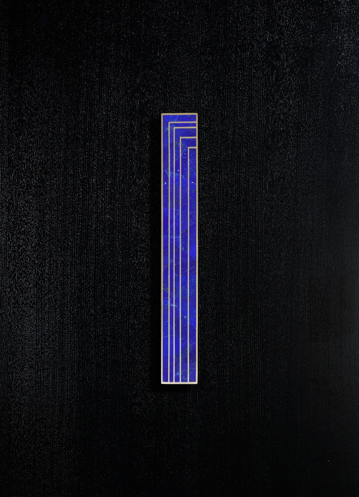 A vertical rectangular tile with a blue marble pattern and gold outlining, set against a black textured background.