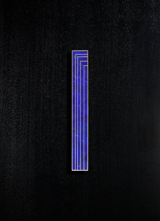A vertical rectangular tile with a blue marble pattern and gold outlining, set against a black textured background.
