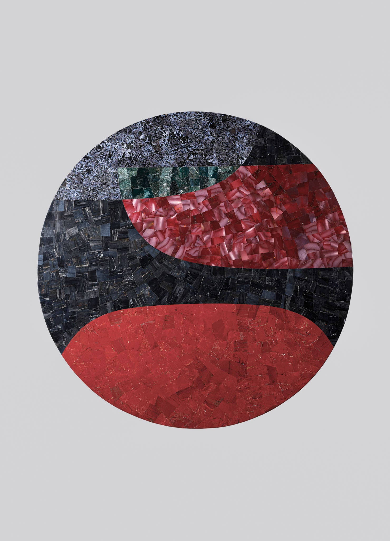 Abstract mosaic artwork with geometric and organic shapes composed of small, polished stone pieces in shades of red, black, green, and gray, arranged on a light gray background.