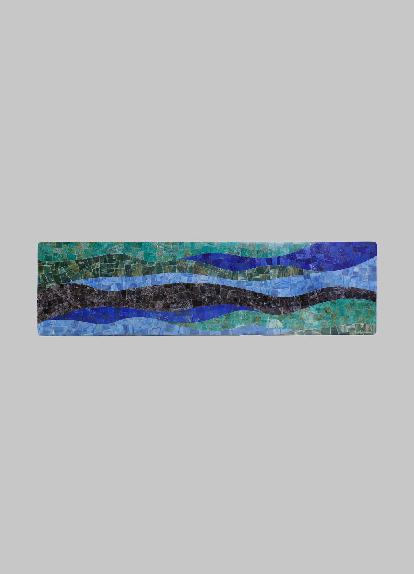 Mosaic tile artwork featuring abstract, flowing waves in shades of blue, green, and black, with a textured surface and irregular geometric pieces set against a light gray background.