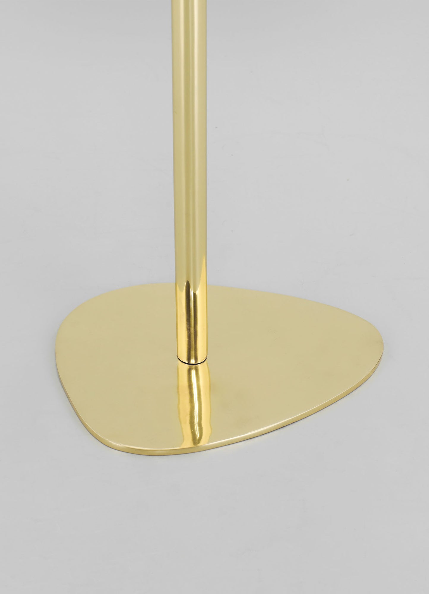 A gold-colored lamp base with a smooth, rounded shape and a polished finish, featuring a vertical cylindrical stem and a wide, flat circular foot on a plain light background.
