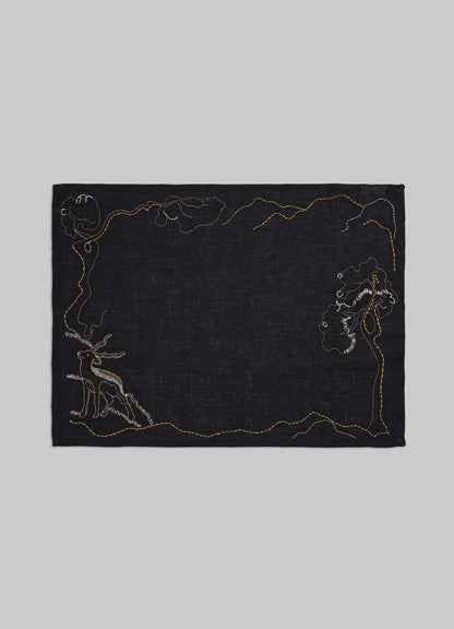 Black fabric with embroidered designs on a gray background placemats viya