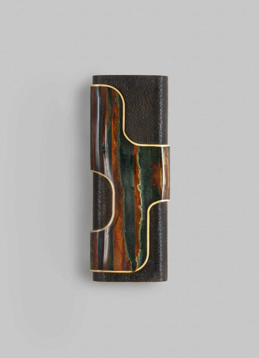 A decorative wall sconce with a cylindrical black textured material base and an abstract, multicolored marbled glass accent featuring earthy tones of green, orange, and brown, outlined with gold trim.