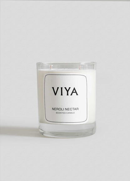 VIYA Neroli Nectar scented candle on a white background viya luxury wax candle stand