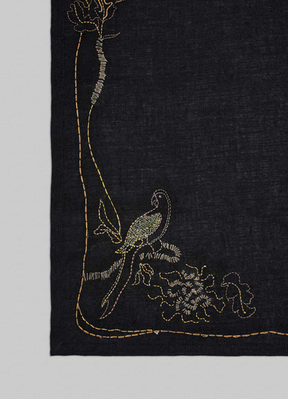 Embroidered fabric with a bird and floral design on a black background viya luxury placemats