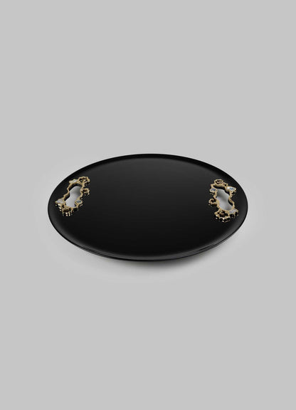 A black oval tray with a glossy finish, accented by two gold-toned decorative handles with ornate, floral motifs.
