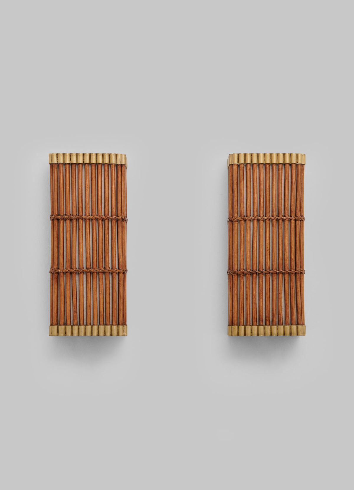 Two identical rectangular bamboo sushi rolling mats are placed side by side on a plain light gray background, evoking the elegance and artisanal craftsmanship of the Namsai Wall Sconce by VIYA, which draws inspiration from traditional Indian cane-working techniques.