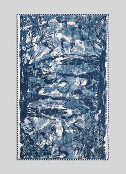 Blue and white patterned towel on a light gray background viya