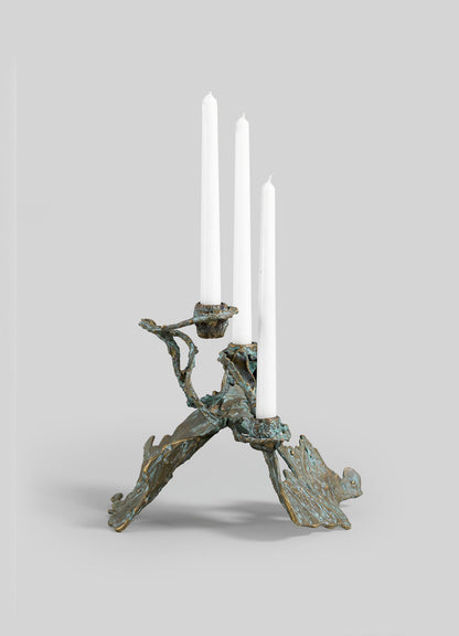 The VIYA Butterfly Candle Stand Small is a sculptural bronze candelabra with three white taper candles, showcasing organic textured branches and leaf-like forms, set against a plain gray background.