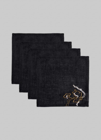 Set of four Viya Blackbuck Dreams Hand Embroidered Black & Gold Cocktail Napkins, each featuring a gold rooster motif on black fabric, neatly stacked against a light gray background.