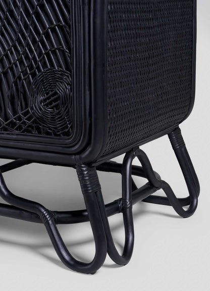 Close-up of the corner and legs of the VIYA Chakra Cabinet, showcasing intricate cane weaving, a curved frame, and tubular legs connected at the base for a stylish chakra decor touch.