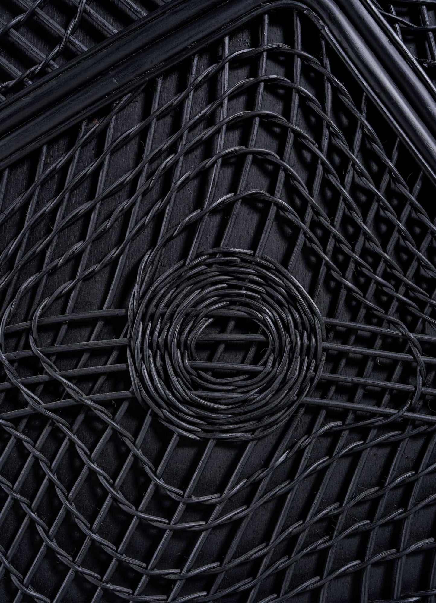 Close-up of the VIYA Chakra Cabinet showcases its black woven pattern with a central circular chakra-inspired design, intersecting lines, and thick black borders.