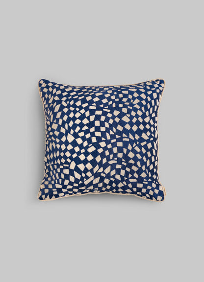 The Viya Dreamscape Blue Embroidered Checks Cushion Cover (18"x18") features an abstract white check pattern on a dark blue background, inspired by textile motifs, shown against a plain light grey backdrop.