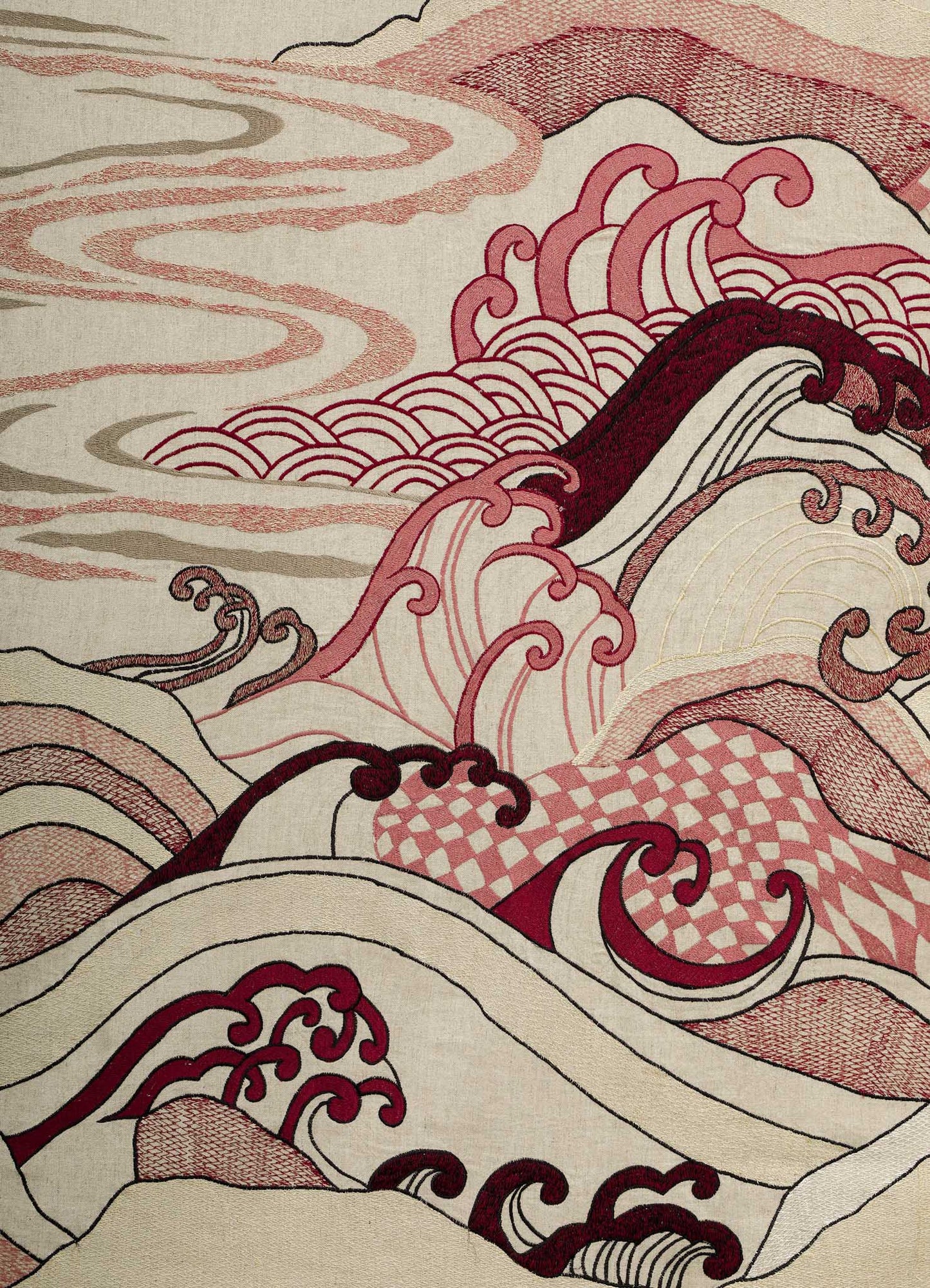 The Dreamscape Ecru Embroidered Bedcover by Viya features abstract waves and clouds in red, pink, and cream, with intricate patterns and flowing lines inspired by traditional Japanese art.