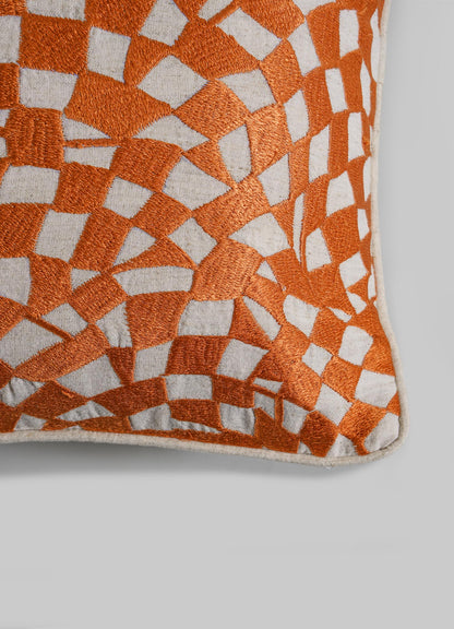 The Viya Dreamscape Orange Embroidered Checks Cushion Cover 18"x18" features an abstract geometric orange and white pattern on a light gray background, inspired by embroidered textile motifs and resembling irregular mosaic shapes.
