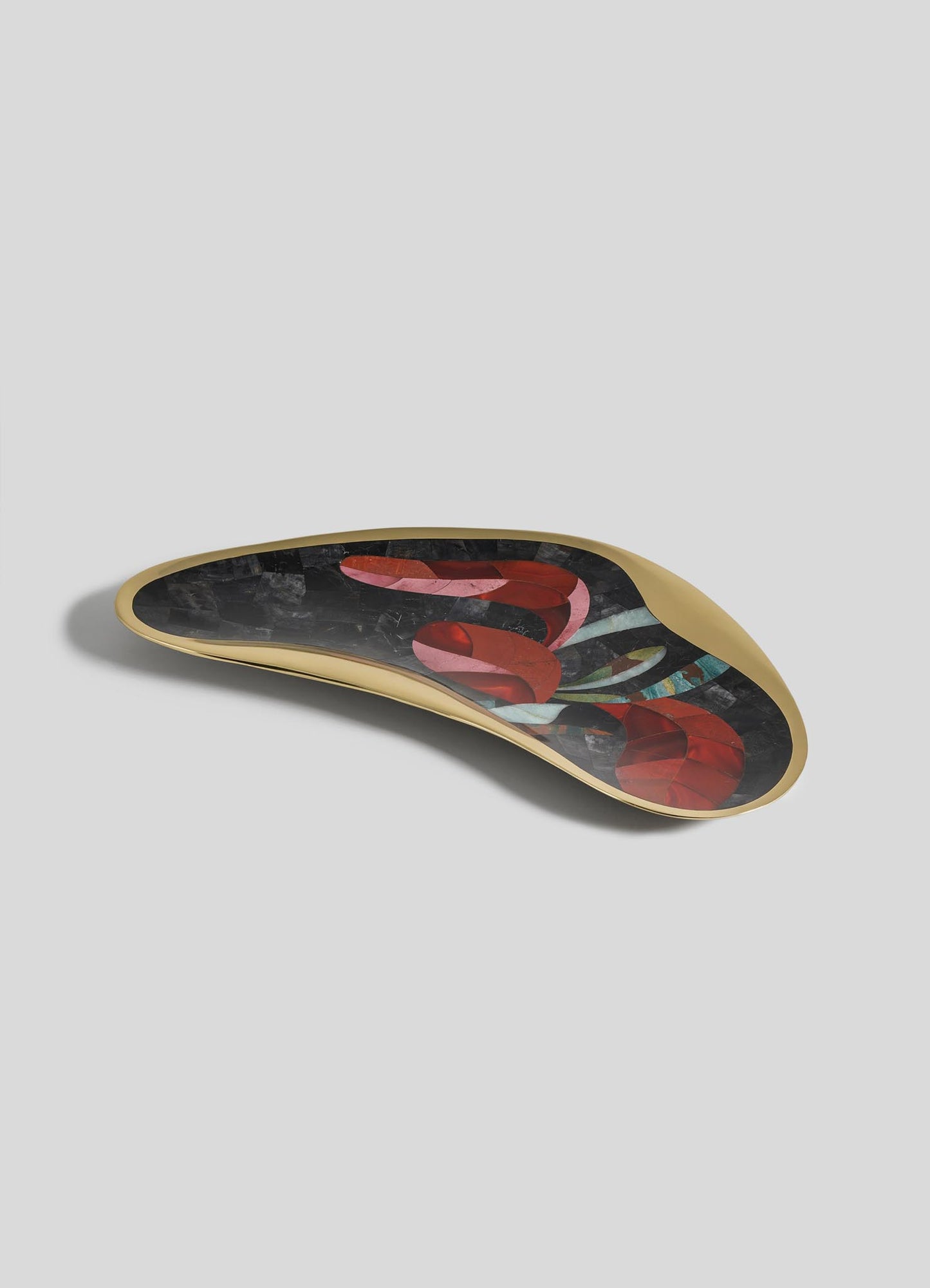 The VIYA Gardens Of India Bowl Large features an asymmetrical, gold-edged design with a glossy black surface and abstract red, blue, and gray patterns, photographed against a light gray background.