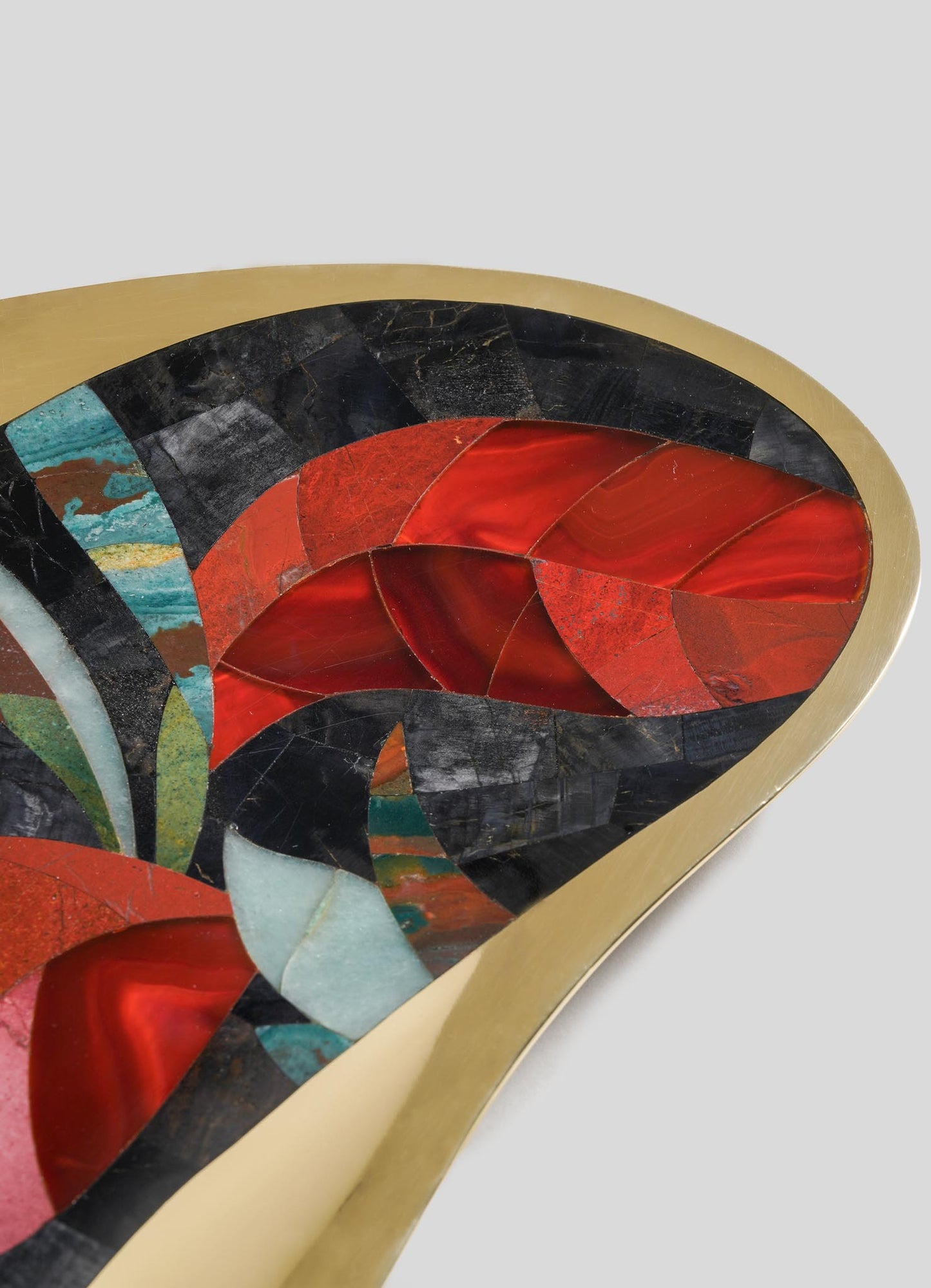 Close-up of VIYA’s Gardens Of India Bowl Large: a decorative tabletop piece with an abstract mosaic pattern in red, black, teal, and white stones, bordered by a smooth gold frame—capturing the colorful essence of Indian gardens.