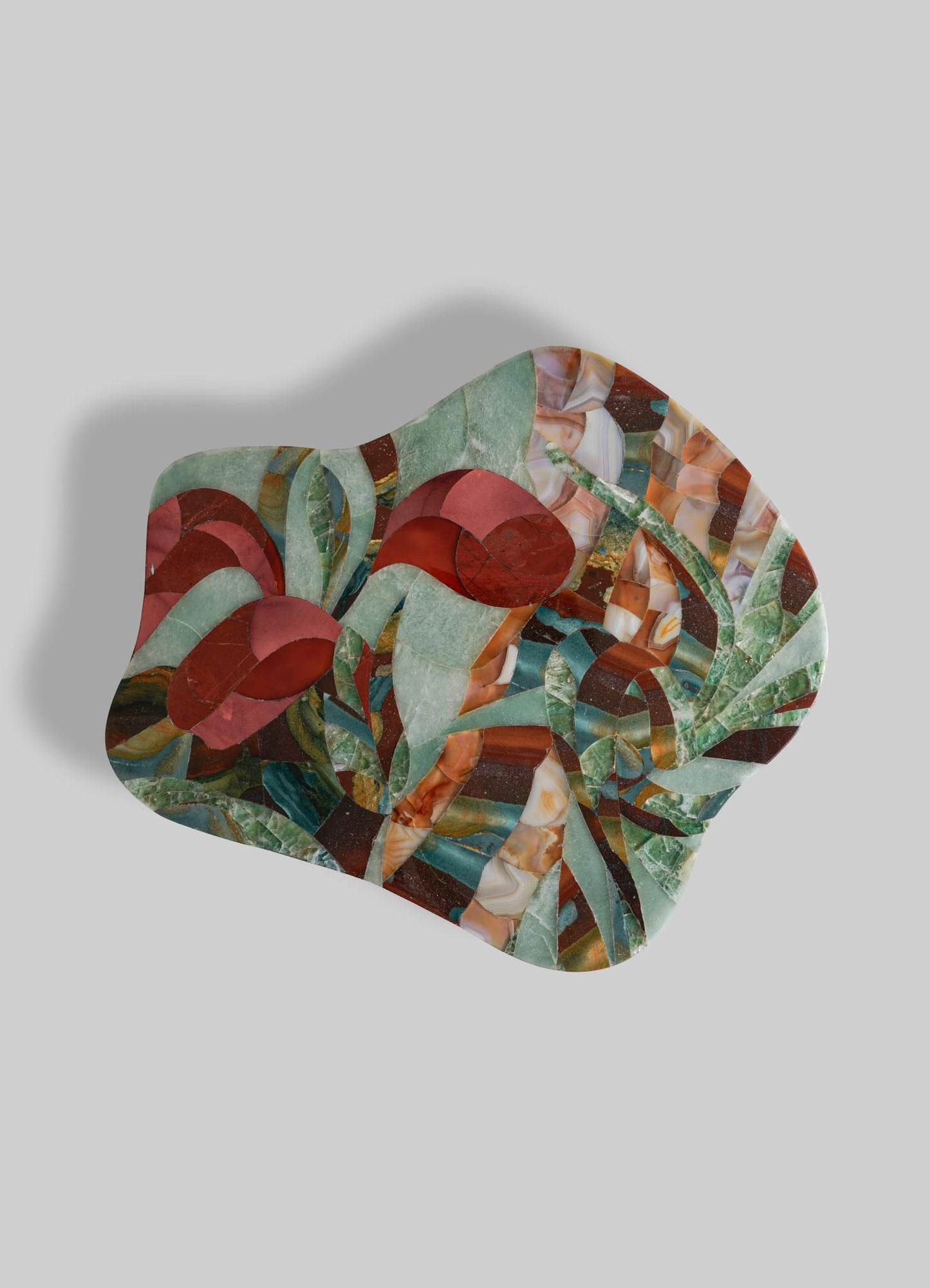 The VIYA Glory Lily Multicolour Side Table Large features abstract artwork with swirling green, red, and brown patterns, organic leaf-like shapes, and two Glory Lily–inspired flowers on an irregular light gray base.