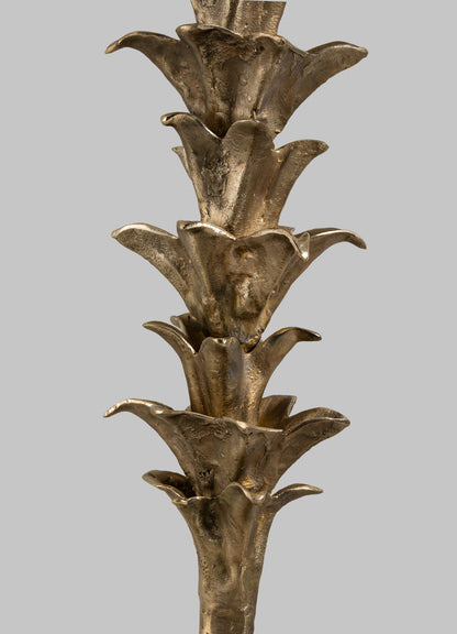 A close-up of the VIYA Indian Vessel Finial, a sculpted metallic piece with stacked, stylized petal or leaf shapes and a bronze-like finish, inspired by traditional brass decor, set against a plain gray background.