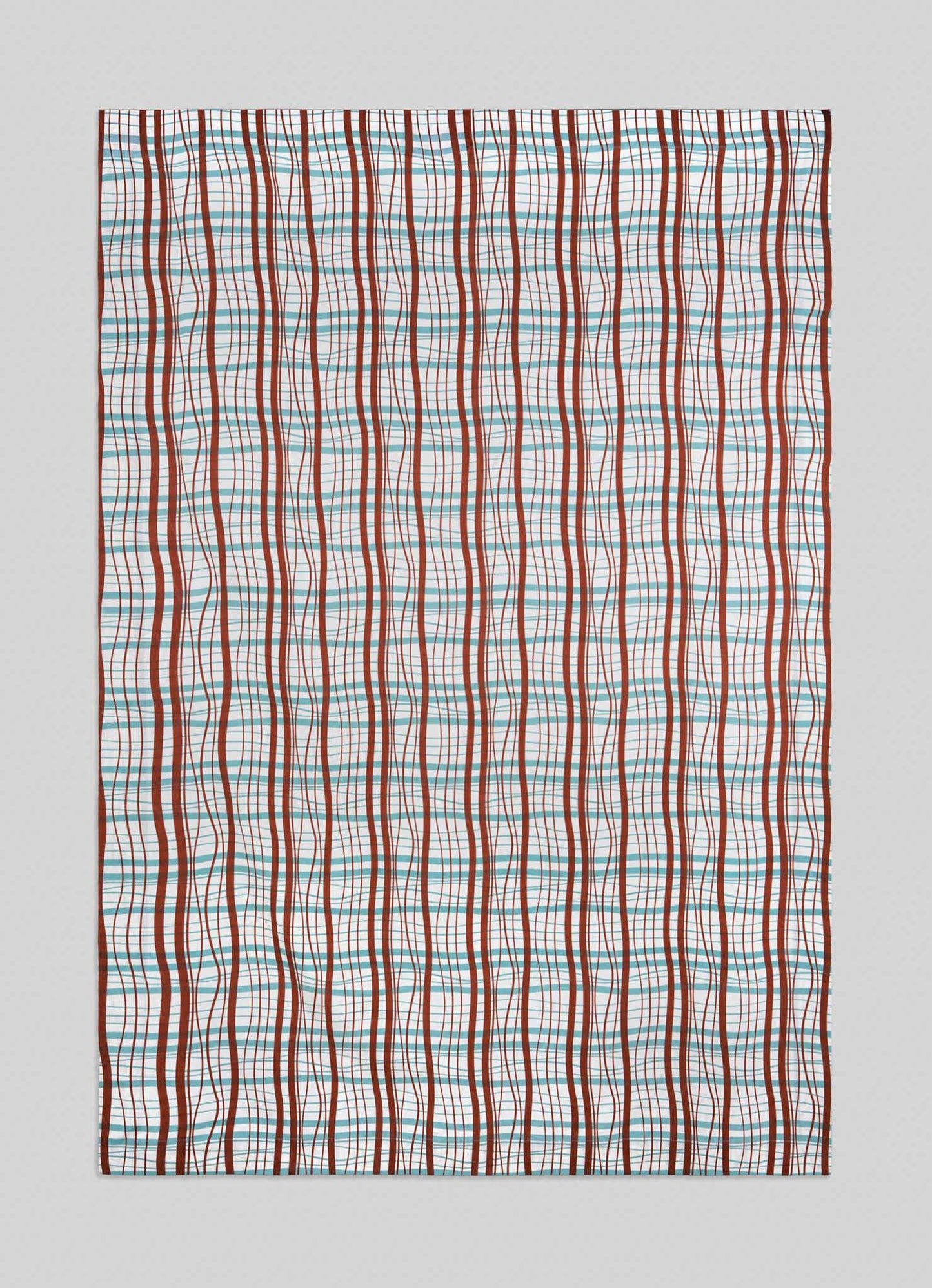 The Madras Check Aqua & Rust Table Cloth by Viya features vertical wavy red lines and straight blue, pink, and green lines forming a grid on white, offering a modern take inspired by traditional Indian Madras checks.