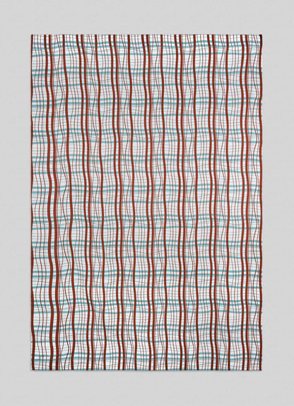 The Madras Check Aqua & Rust Table Cloth by Viya features vertical wavy red lines and straight blue, pink, and green lines forming a grid on white, offering a modern take inspired by traditional Indian Madras checks.